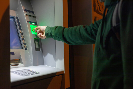 man's hands inserting a credit card