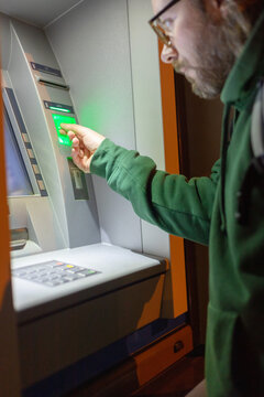 the guy inserts a credit card into the terminal