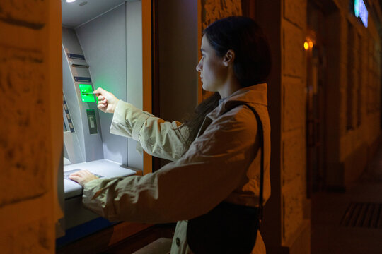 night portrait of a girl at an ATM