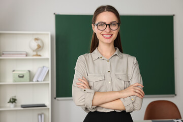 Portrait of beautiful young teacher in classroom