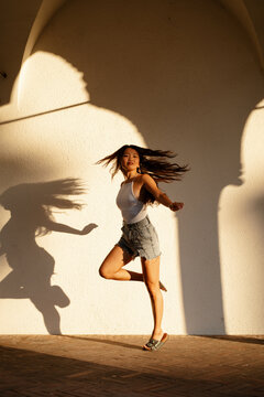 Dancer dancing in urban area at sunset