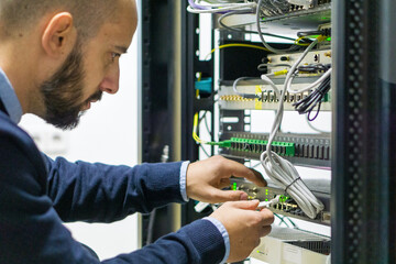 Network engineer working in a telecom rack