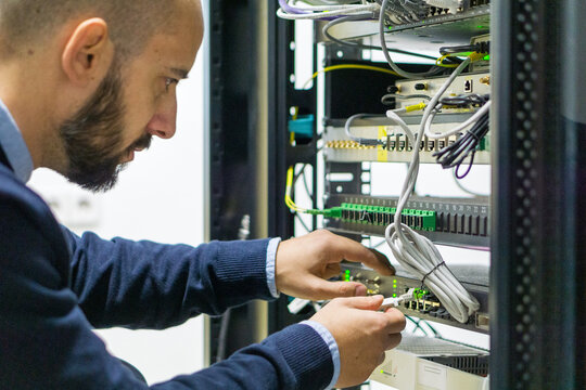 Network engineer working in a telecom rack
