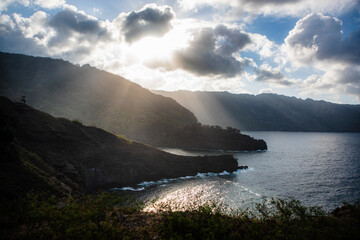 View of the bay of the Hanapaaoa Valley in Hiva Oa, Marquesas Islands, French Polynesia. Sea side with rock. the sun illuminates the coast with rays through the clouds.