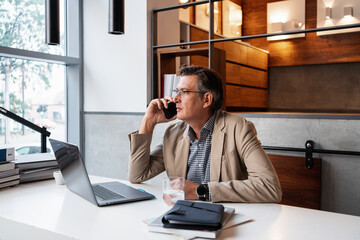 Businessman Talking On The Phone In The Workplace
