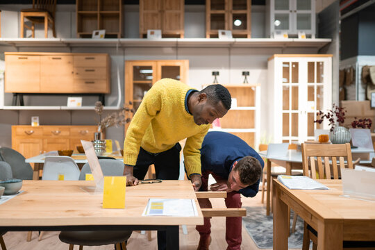 People Selecting Table In The Shop