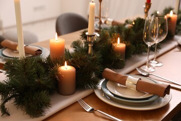 Luxury place setting with beautiful festive decor for Christmas dinner on wooden table