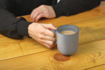 person holding a mug with coffee