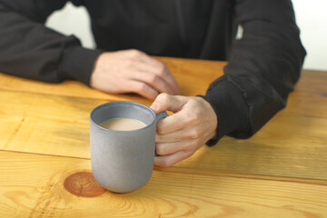 person holding a mug with coffee
