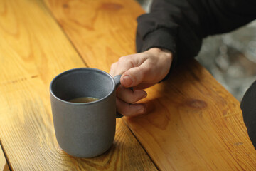 person holding a mug with coffee