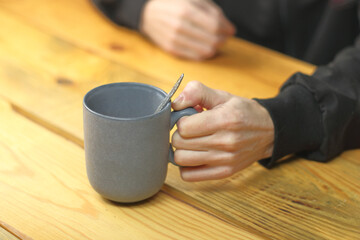 person holding a mug with coffee