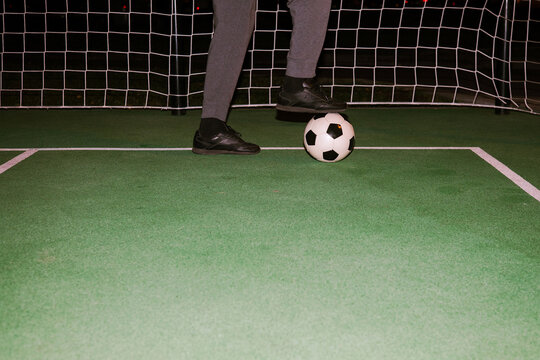 Man play with soccers ball in the football field. 
