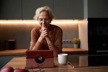 Woman using digital tablet relaxed at home.