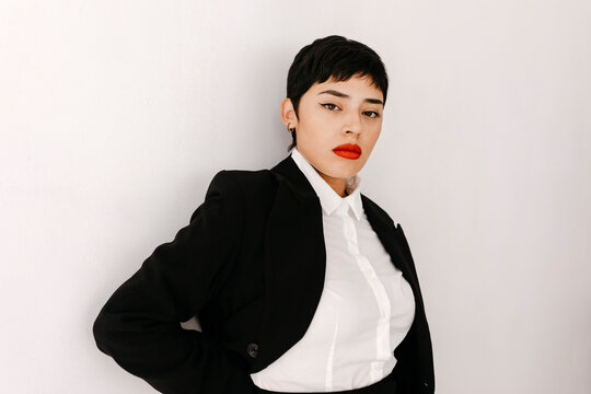 Confident Latin American woman with pixie cut and red lips