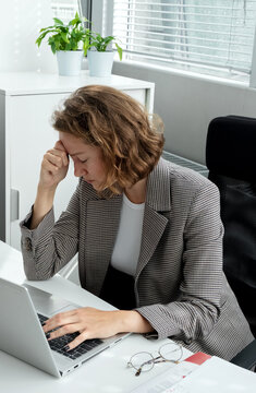 A Business Woman Sitting At Her Desk In The Office