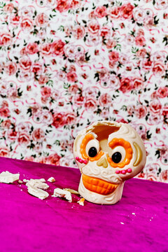 broken sugar skull on a violet velvet surface