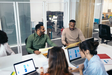Group of office colleagues working cooperatively in a coworking