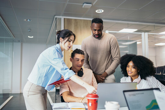 Group of office colleagues working cooperatively in a coworking