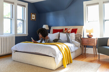 Black Girl house on video chat with smartphone in bedroom 