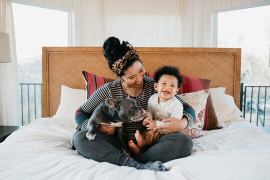 Portrait of a mother and her 1 year old child and her french bulldog