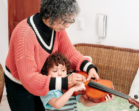 Teacher teaching a child how to play the violin