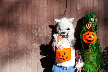 kids with halloween costumes with scary masks