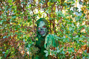 Zombie boy surrounded by vegetation