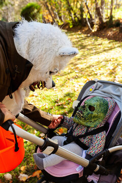 Father and toddler on stroller wearing Halloween costumes
