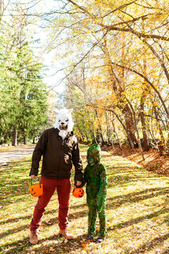 Father and son with scary masks on Halloween