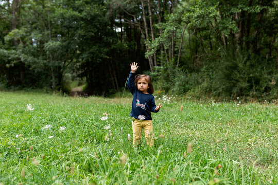 Cute girl walking through the meadow