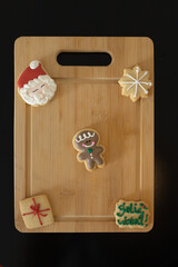 wooden kitchen board with christmas cookie decor with copy space