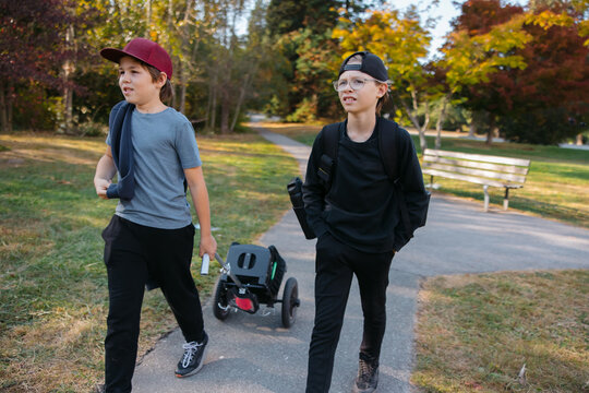 Two friends - brothers - enjoying disc golf together.