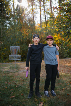 Two friends - brothers - enjoying disc golf together.