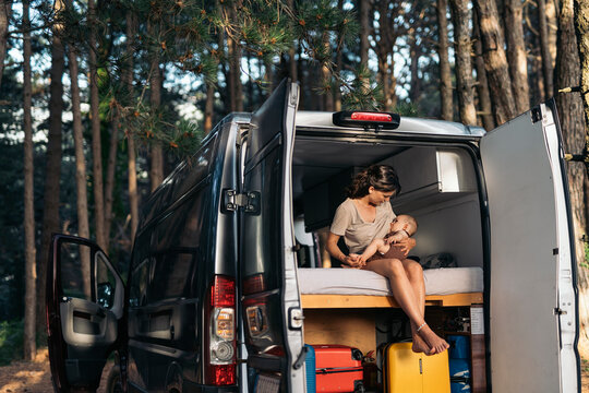 Mother Breastfeeding her Baby in a Camper