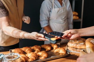 Customer Paying in Bakery Using Phone