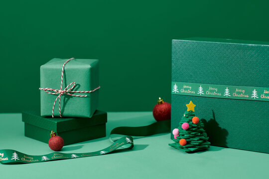 Christmas card with green Xmas gifts, pine tree, balls