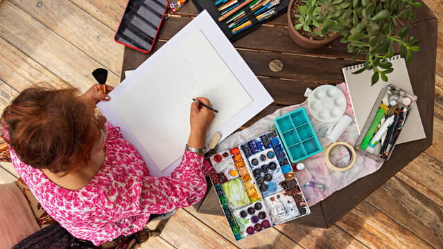 Overhead Shot Of Old Woman Making Sketch