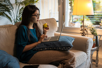 Student browsing laptop at home