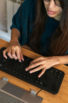 Woman youtuber editing video with editing console