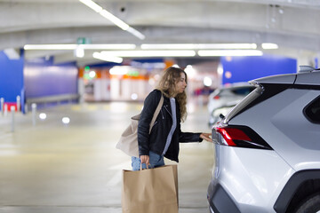 Woman opens car trunk