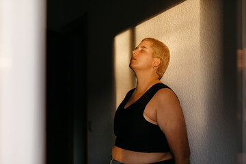 Model standing in sun shining through window