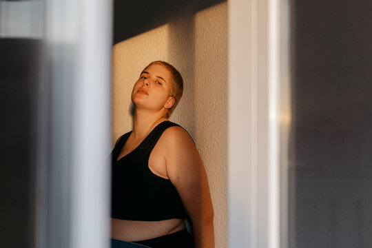 Emotionless non binary person in sunset light