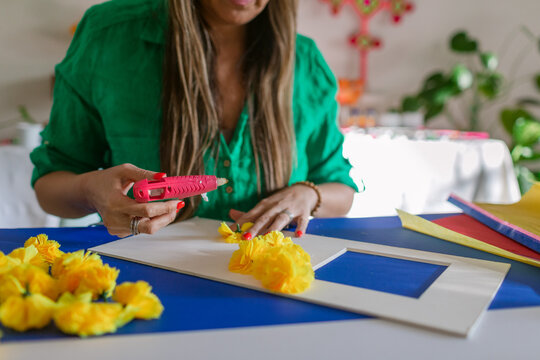 Woman making arch of flowers for altar