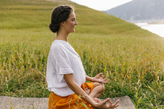 Woman Focused On Meditation, Practising Yoga In Nature