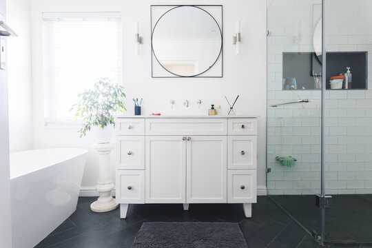 General view of luxury bathroom with shower, bath, washbasin and mirror