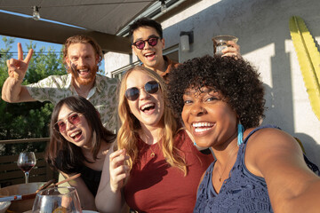 Group of friends taking selfie outdoors