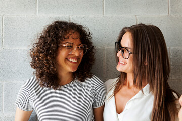 Female friends laughing looking each other
