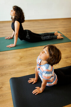 Mother and son doing yoga together in studio