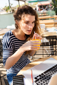Young student woman studying at terrace bar