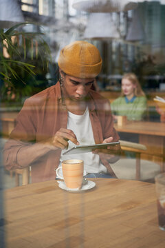 Man Working And Studying At Coffee Shop